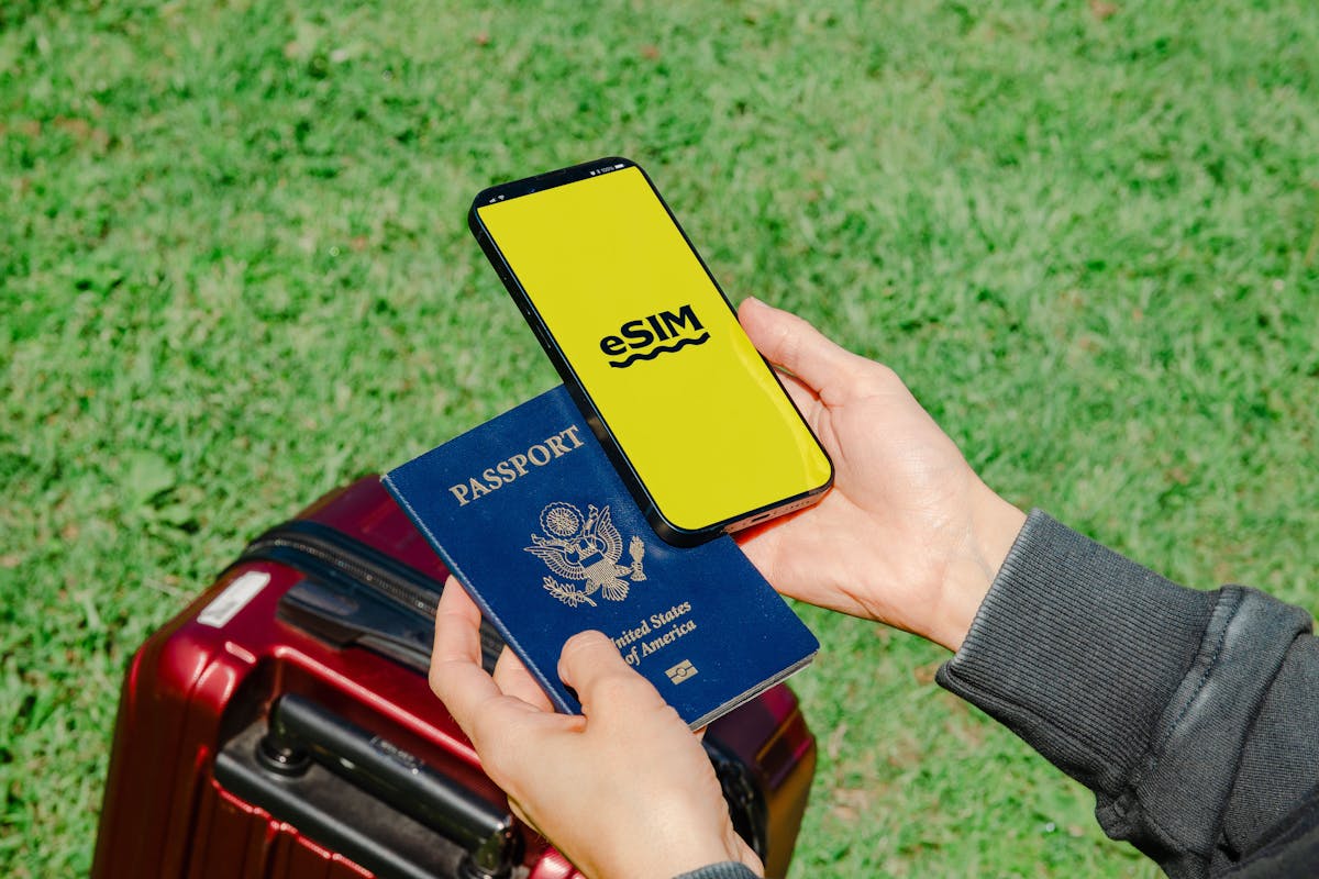 Person holding passport and smartphone ready for UK travel with eSIM