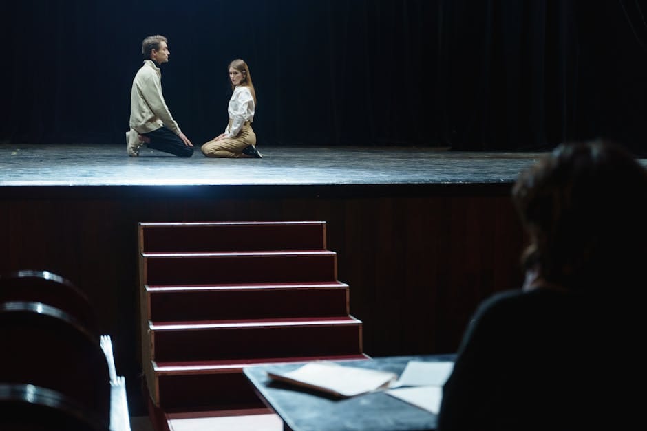 Stratford US travelers - actors in dramatic rehearsal under dim theater lights