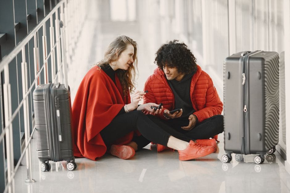 Grandparent and grandchild reuniting at a UK arrivals hall