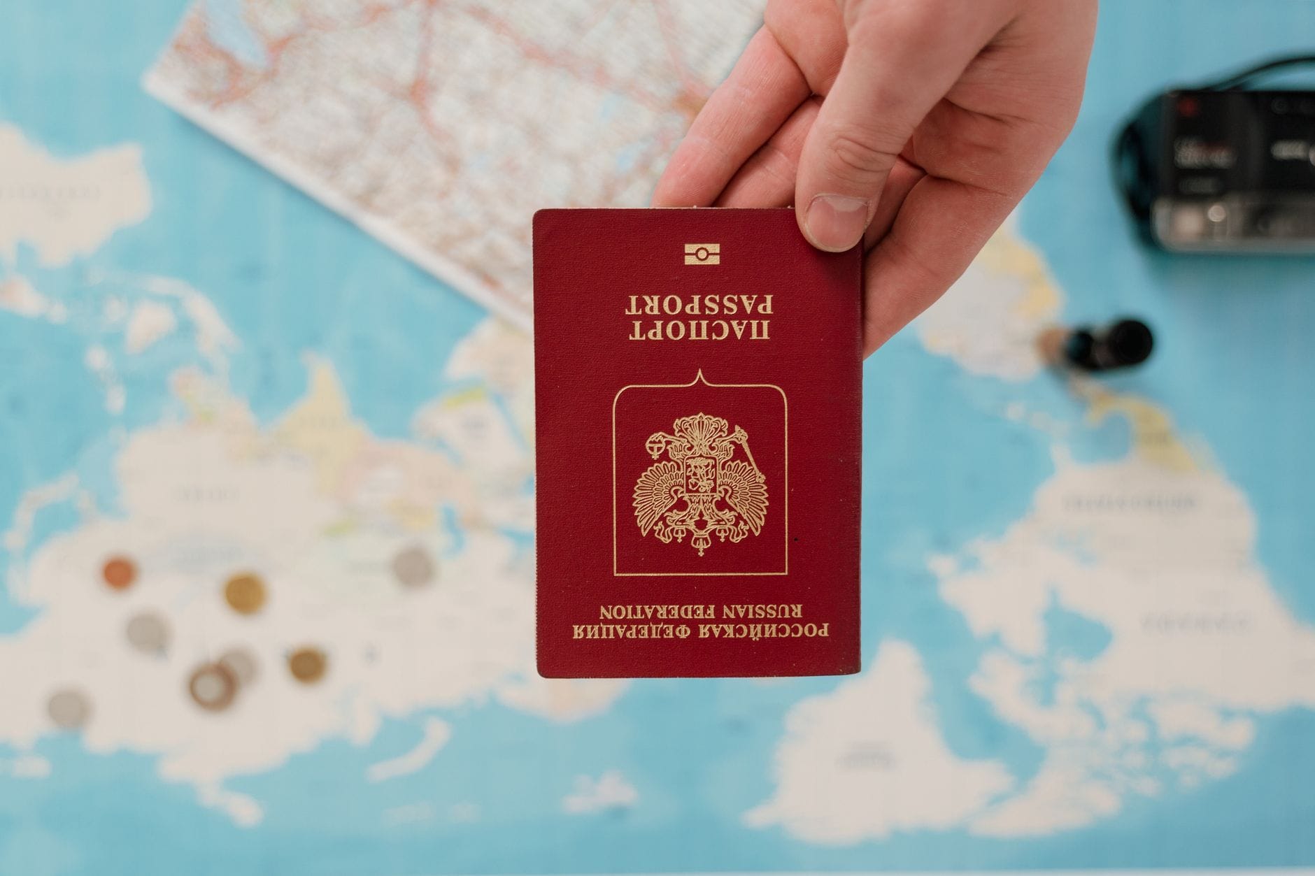 A traveler holding a passport and printed travel documents at airport arrivals