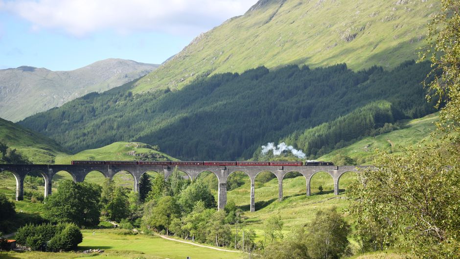 Train crossing the green Scottish countryside on the way toward Edinburgh
