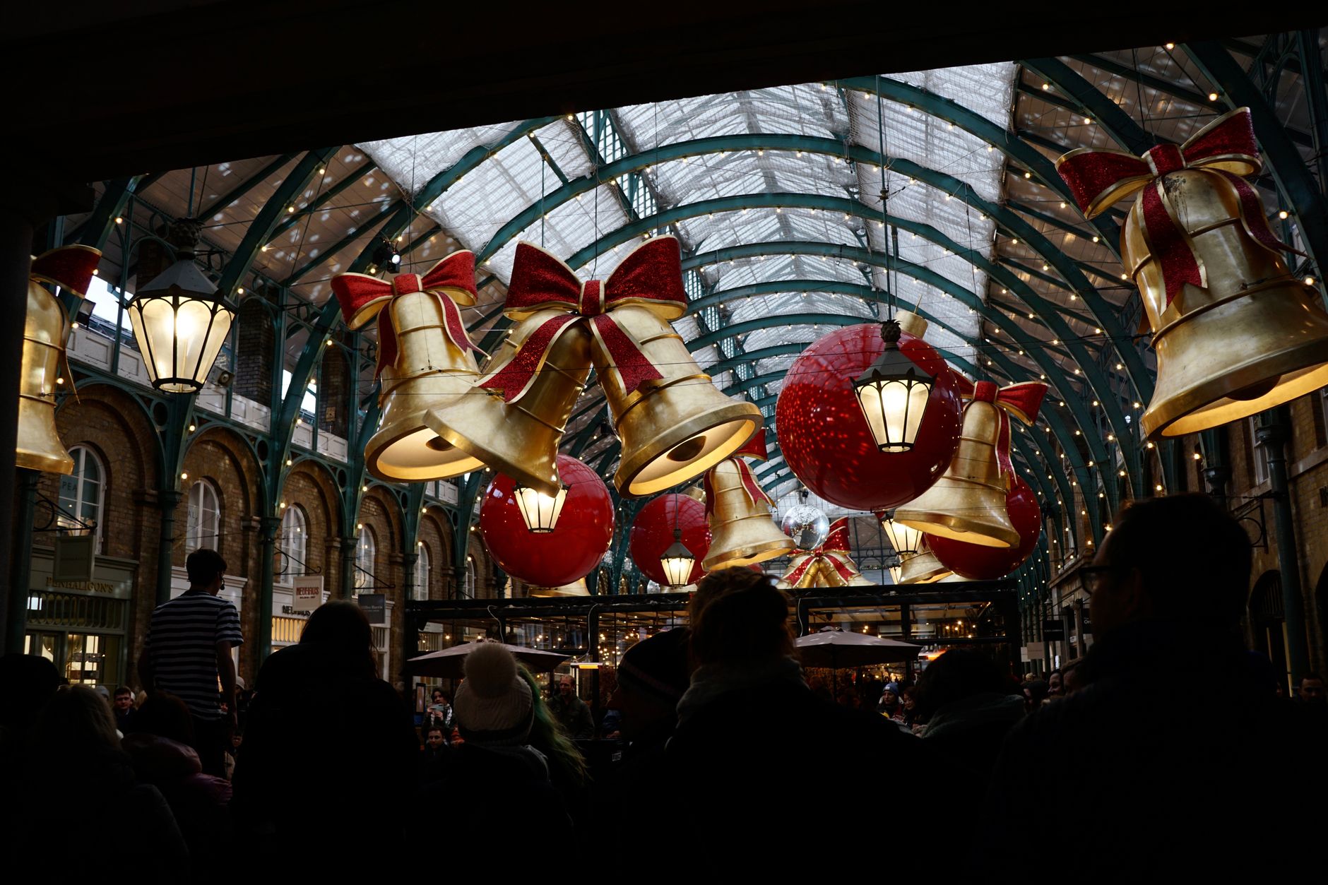A festive Christmas market glowing with lights on a cold winter evening in central London