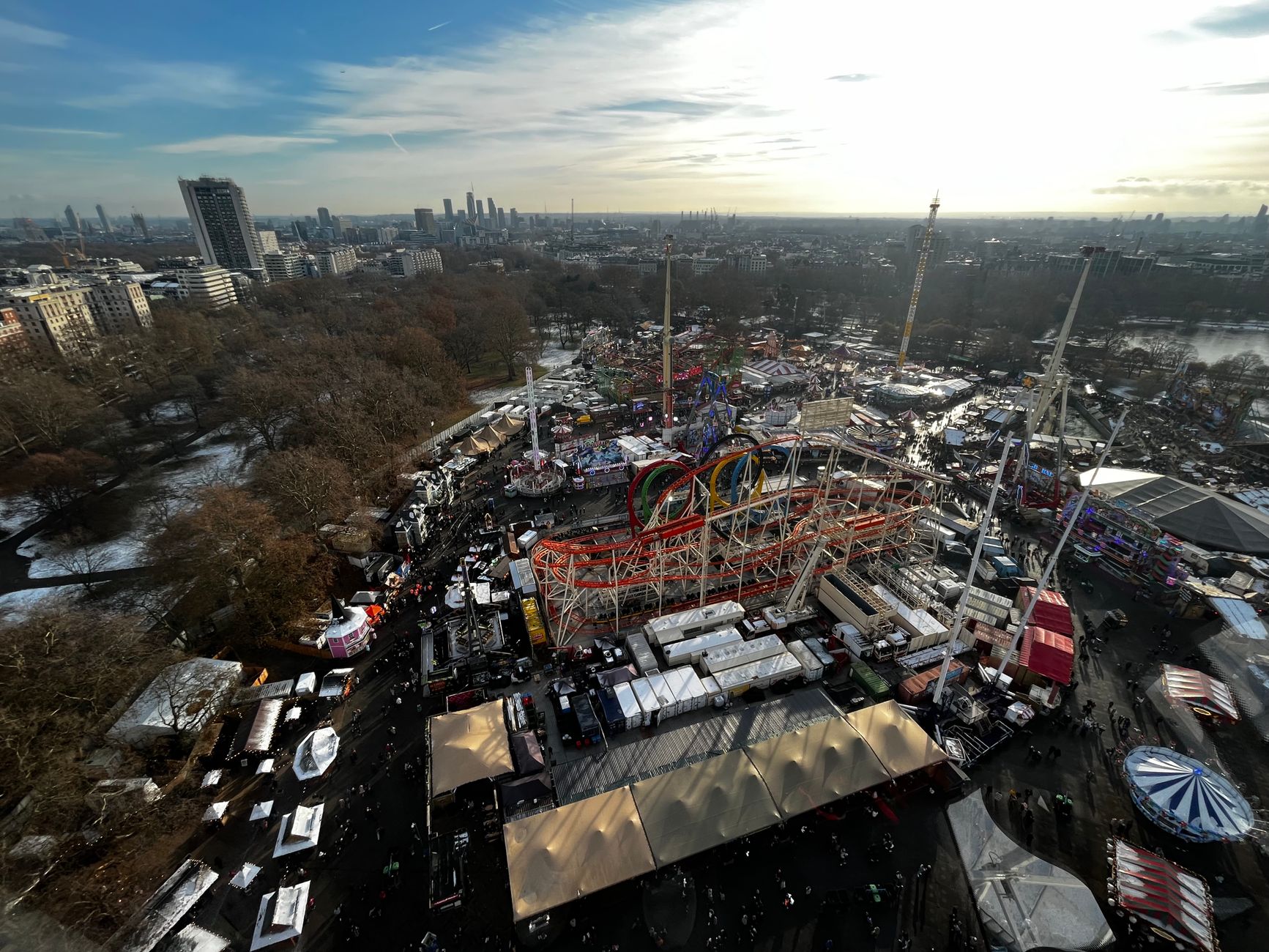 A dazzling winter funfair with illuminated rides and Christmas lights in a London park at dusk