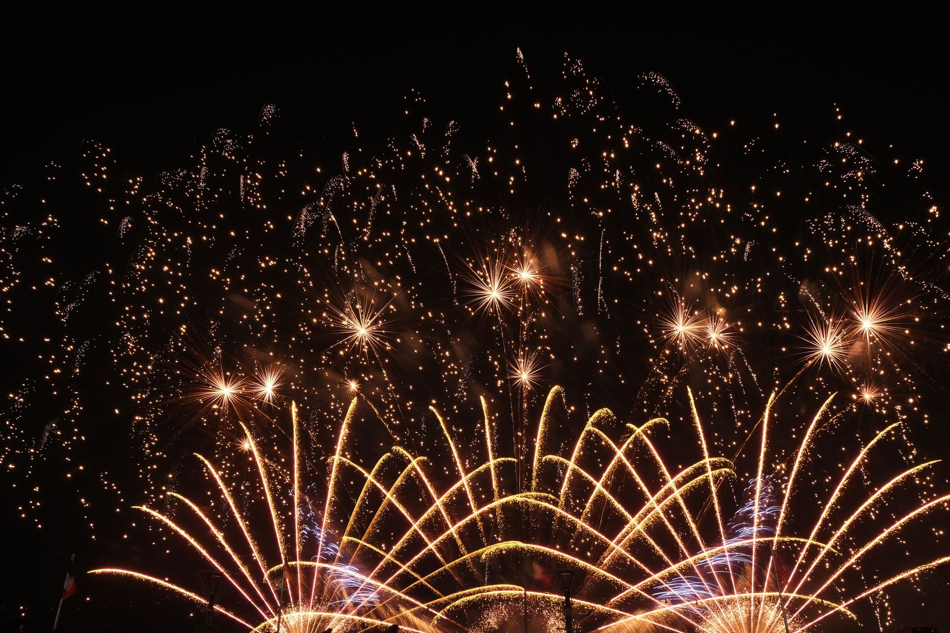 A crowd celebrating New Year's Eve outdoors in a city