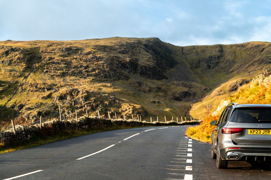 Rental car on a scenic road for an Ireland to Northern Ireland cross-border drive