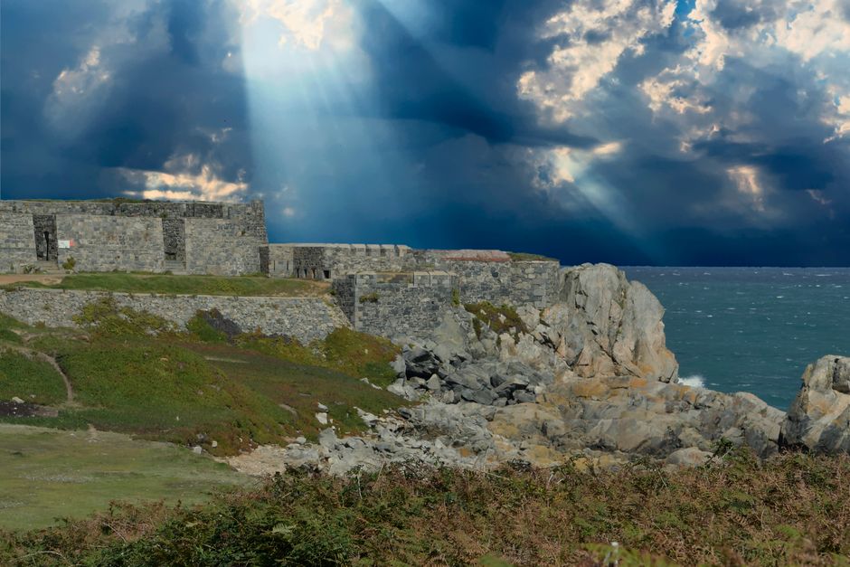 Coastal cliffs of Jersey in the Channel Islands under a blue sky