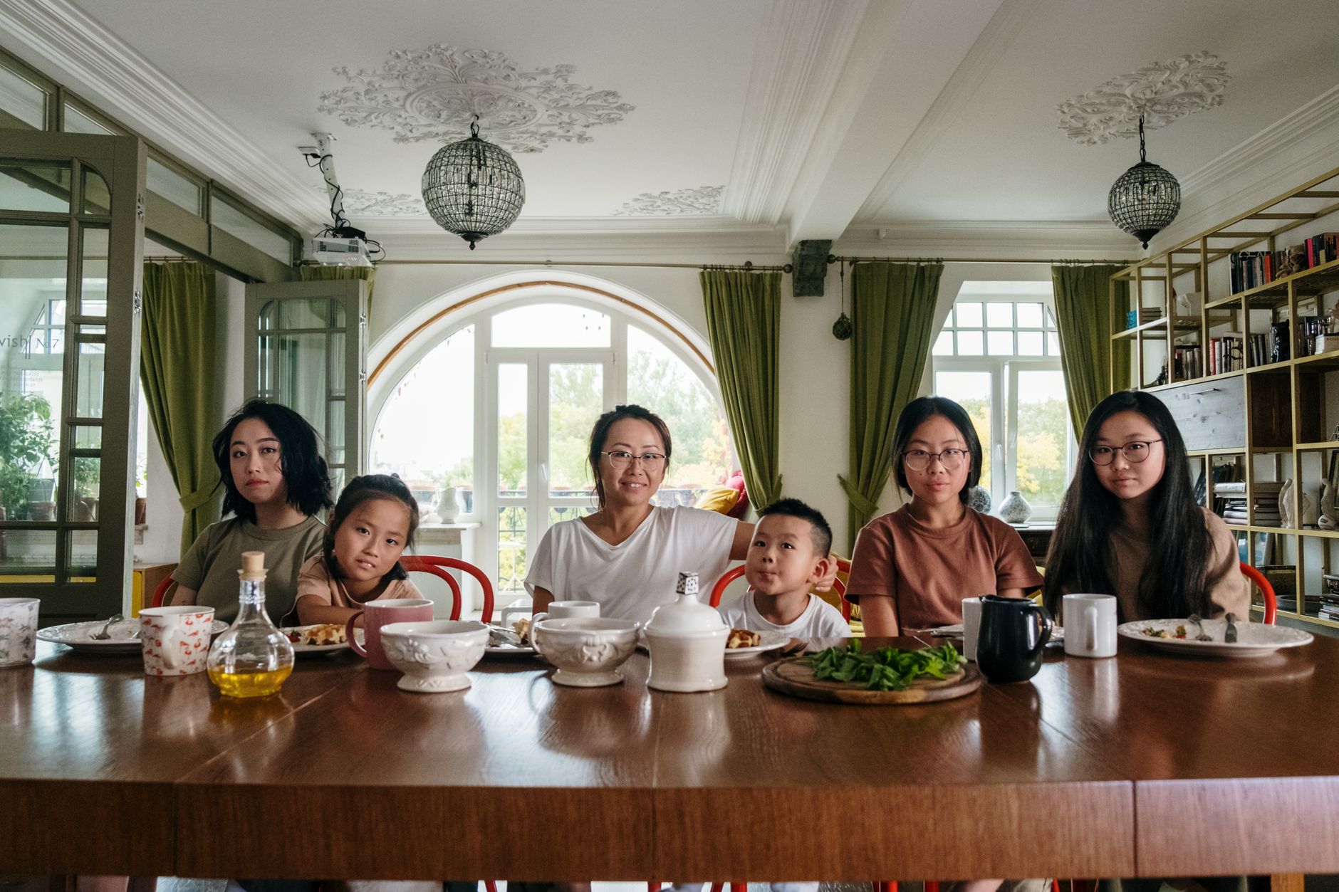 Extended family sharing a meal in a home during a visit to the United Kingdom